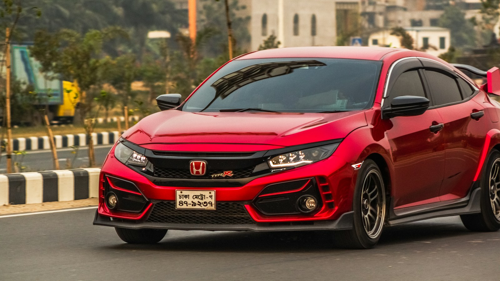 Red Honda Civic Type R parked on a road; photograph by Bornil Amin on Unsplash